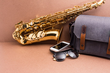 Saxophonist and accessories  for travel on rustic wooden backgro