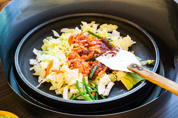 One of Korean favorite : Korean spicy stir fried vegetable, chicken and Korean spicy sauce (Gochujang) in big hot pan know as Dak Galbi