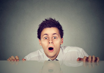 worried young man looks at camera