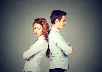 Angry frustrated young couple standing back to back