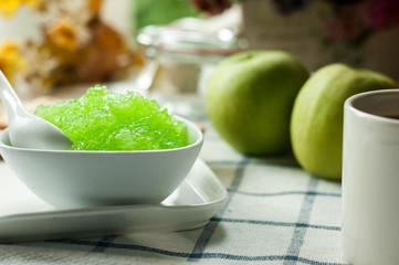 apple jam and crackers, coffee cup on the table, light from the window