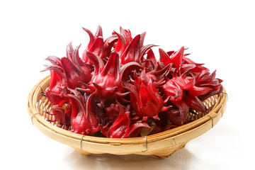 Roselle fruits in bamboo basket, isolated on white
