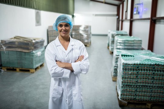 Portrait of female staff standing in egg factory