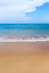 white soft wave on empty tropical beach and blue sea with blue sky and white cloud background
