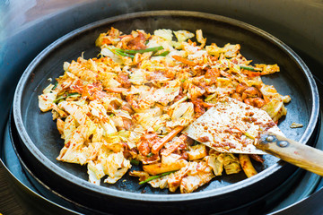 One of Korean favorite : Korean spicy stir fried vegetable, chicken and Korean spicy sauce (Gochujang) in big hot pan know as Dak Galbi