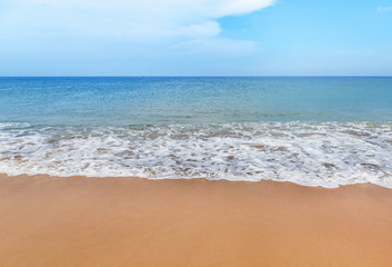 Fototapeta na wymiar white soft wave on empty tropical beach and blue sea with blue sky and white cloud background