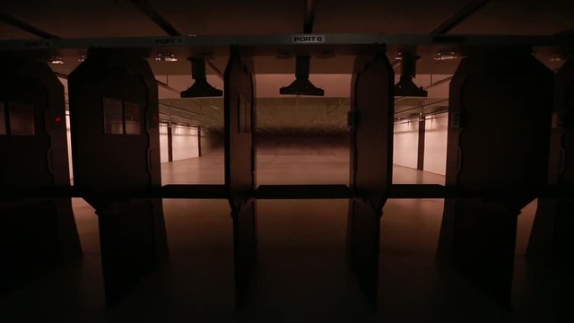 Indoor gun range, pan, pan across empty gun range.