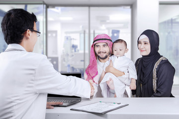 Middle eastern families handshake with pediatrician