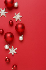 Christmas ornaments decorations background. Classic red and white glass baubles balls with giltter snowflakes vertical border.