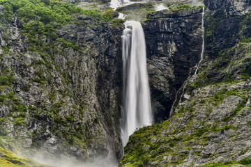 Fototapeta premium landscape of a small waterfall cascading in a pool of water