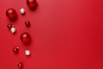 Christmas ornaments decorations background. Classic bright red and white glass baubles balls horizontal border.