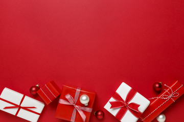 Christmas gifts presents on red background. Simple, classic red and white wrapped gift boxes with...