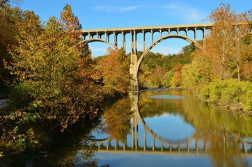 Fototapeta na wymiar bridge overpass and reflection on lake in Autumn
