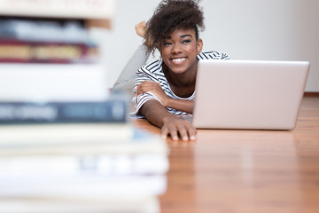 African American woman using a laptop in her living room