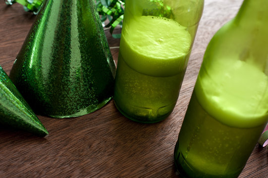 Table with green beer bottles and party hat