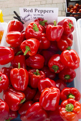 Ripe red peppers at a farmers' market stand