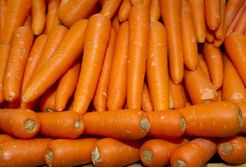 A lot of carrots stacked in market