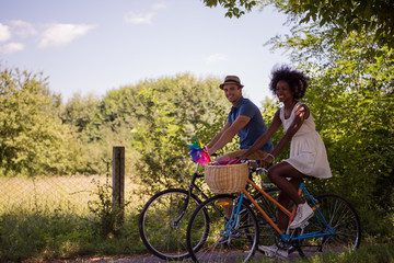 Obraz premium Young multiethnic couple having a bike ride in nature