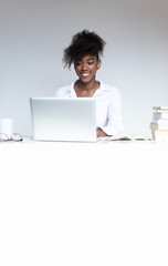 Portrait of beautiful smiling afro-american office worker sittin