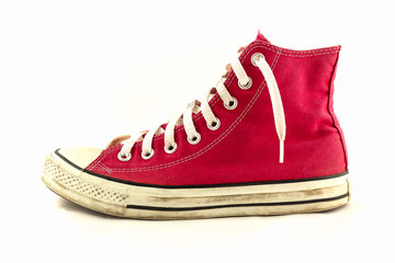Old red sneaker isolated on white background / Image Selective focus.