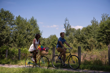 Young multiethnic couple having a bike ride in nature