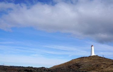 Obraz premium Beautiful Meadow landscape on the road with lighthouse backgroun