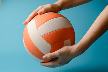 Volleyball in woman hands