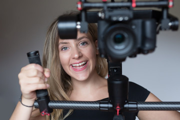 woman videographer using steady cam, Professional equipment help