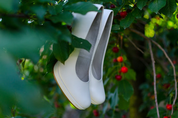 Wedding shoes hanging on the cherry tree