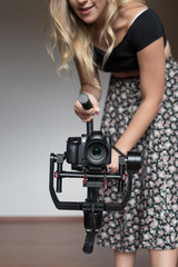 Professional  woman videographer with gimball video slr