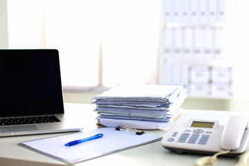 office desk a stack of computer paper reports work forms