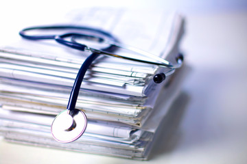 books folder file and stethoscope isolated on white background