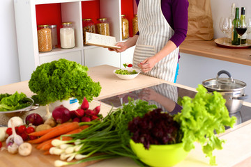 Young Woman Cooking in the kitchen. Healthy Food