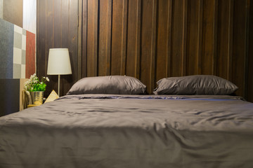 bedroom interior with wood head board and gray color theme