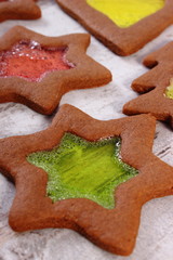 Stained glass gingerbread on old wooden background, christmas time