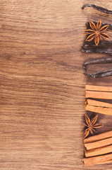 Vintage photo, Vanilla, cinnamon sticks, anise on wooden surface, copy space for text