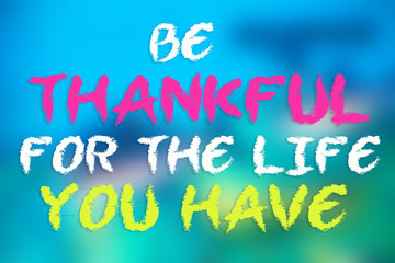 BE THANKFUL FOR THE LIFE YOU HAVE card on blurred blue background