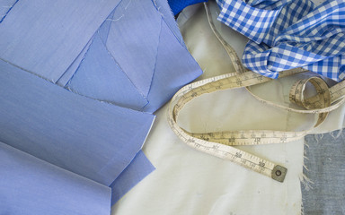 Dress shirt pieces and measuring tape in tailor shop