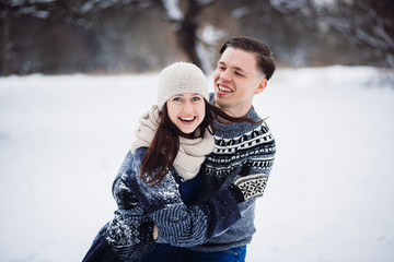 Fototapeta na wymiar Winter couple having fun in snow park.