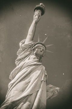 Statue of Liberty in front of blue sky, Liberty Island, New York City, USA, Old style image