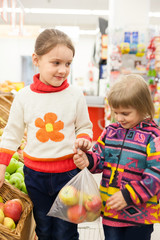 Fototapeta premium children in store at shelves with products.