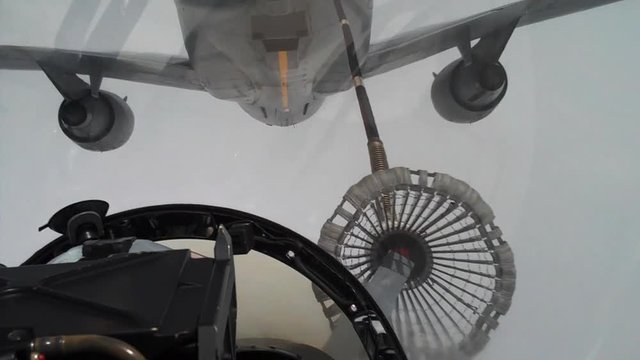 A fighter jet refuels mid-flight, POV shot from cockpit, F/A-18.