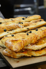 Chiabatta with olives lying on the counter for confectionery sho