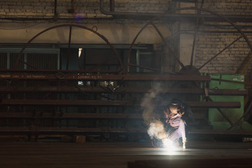 Fototapeta na wymiar Industrial Worker at the factory welding closeup.