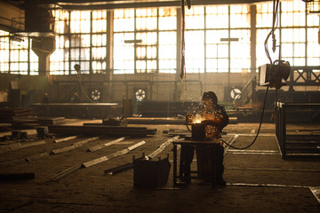 Obraz na płótnie Canvas Industrial Worker at the factory welding closeup.