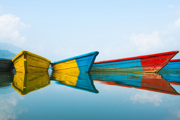 Colorful boats with they reflection on the water.