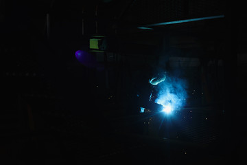 Industrial Worker at the factory welding closeup.