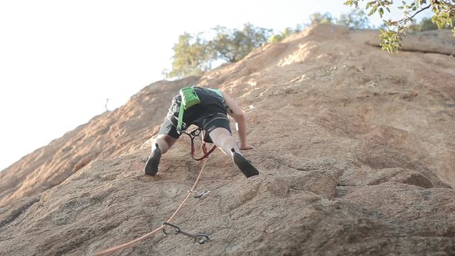 young handsome man Rock Climbing outdoors free climb extreme sports recreation healthy relax holidays sporty muscle health