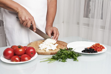 Cutting mozzarella into pieces. Making enchilada tortilla with beef.