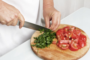 Cutting green parsley. Making enchilada tortilla with beef.